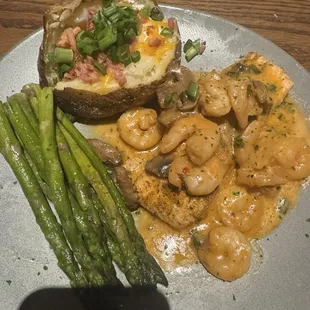 TOOWOOMBA SALMON  Grilled Salmon topped with seasoned and sautéed shrimp tossed with mushrooms in a creamy creole sauce