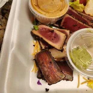 Was told by a manager that the ahi was black/brown because of the seasoning they use.  The first 2 pieces are clearly old