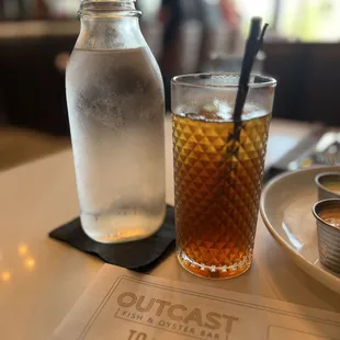  glass of iced tea and a bottle of water