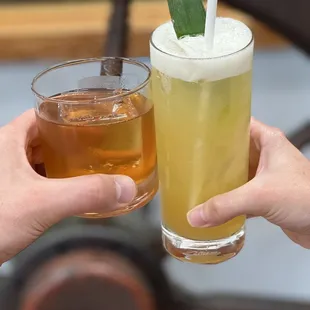 two people holding drinks
