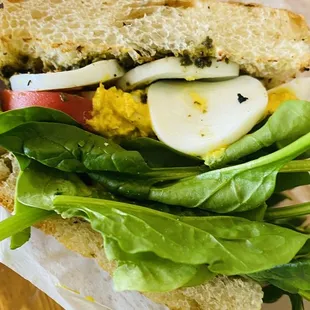 Nana Love Sandwich on focaccia - egg, humus, pesto, spinach, tomato