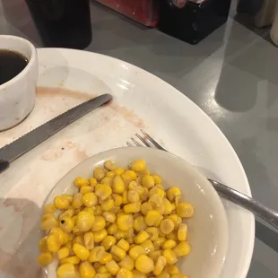 a plate of corn and a cup of coffee
