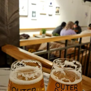 two glasses of beer on a table