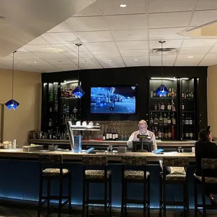 a bar with people sitting at it