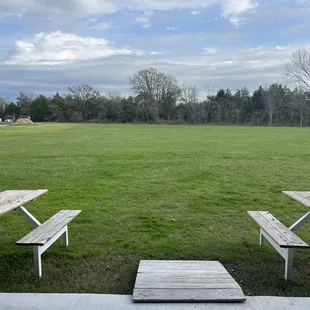 picnic tables in a grassy field