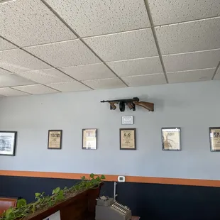a gun mounted on the wall