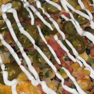 loaded nachos on a wooden platter