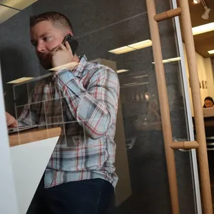Coworking member in the phone booth at Outlet