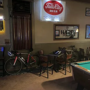 a pool table and a bicycle in a pub