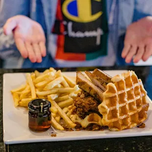Shaggy Belgian Belgian crystalized waffles, homemade fried chicken topped with slow cooked pork belly, topped with maple syrup