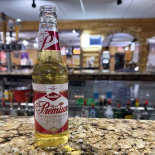 a bottle of beer sitting on a counter