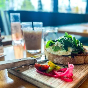REAL AVOCADO TOAST (V) HOUSE MADE RED PEPPER PESTO, FETA CHEESE, ASIAN GREENS, MINT, AVOCADO, OLIVE OIL, THICK COUNTRY TOAST