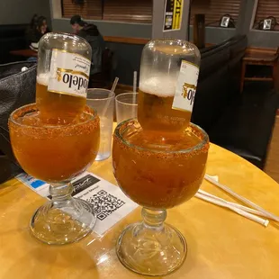 two glasses of beer on a table