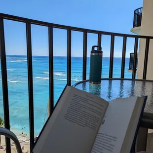 Reading on the balcony with that beautiful view