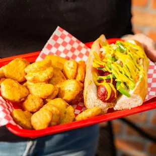 a person holding a tray of food