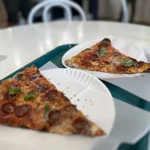 Pepperoni topped with fresh basil, Parmesan, and red pepper flakes