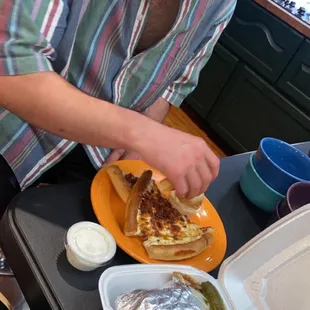 a man eating a sandwich and french fries