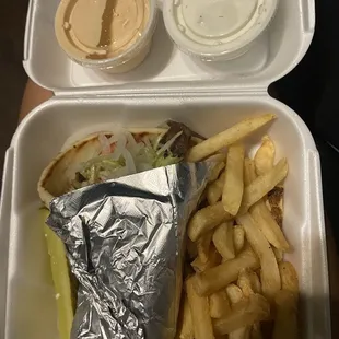 Yummy gyro plate after a long day with extra sauces