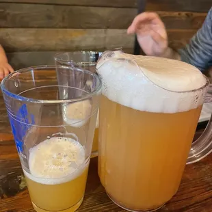 a pitcher of beer and a glass of beer