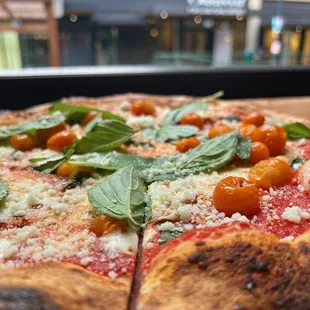 a pizza with tomatoes and basil