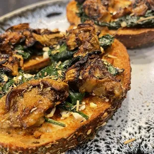 Za'atar bagel with red pesto, feta, sautéed garlic spinach and roasted eggplant