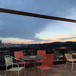 a view of a city from a rooftop restaurant