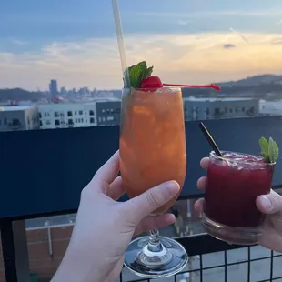 two people toasting with drinks
