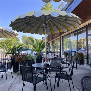 a patio with tables and umbrellas