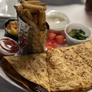 a plate of quesadillas and fries