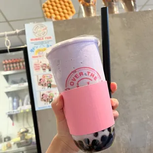 a hand holding a cup of bubble tea