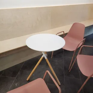 pink chairs and a white table