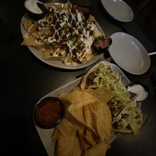 Nachos with ground beef and steak tacos.