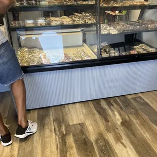 a man standing in front of a display case