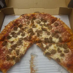 Large sausage pizza sans two slices