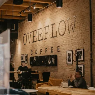 people sitting at tables in a coffee shop