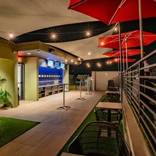 a patio with tables and umbrellas