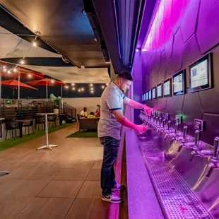 a man standing in front of a public water fountain
