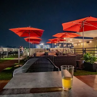 a patio with tables and chairs and umbrellas