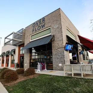 the outside of a restaurant with tables and umbrellas