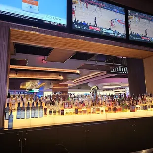 multiple televisions and liquor bottles