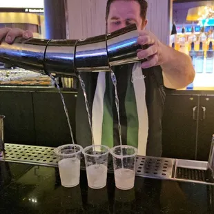 a bartender pouring a drink