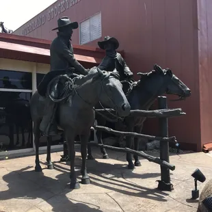 a statue of two men riding horses