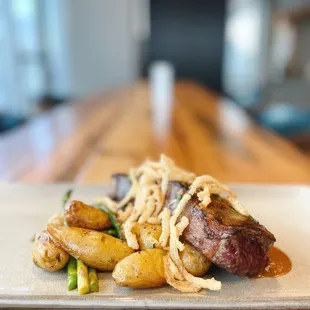 Grilled NY Strip with Roasted Mushrooms, Asparagus, Fingerling Potatoes, Crispy Onions, &amp; House Steak Sauce