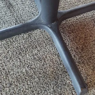 Stained carpet and dirty table legs.
