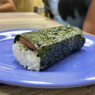 a sushi roll on a blue plate