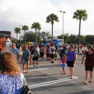 a crowd of people walking down the street