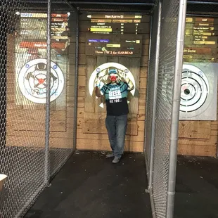 The axe throwing stall, target, and scoreboard