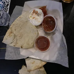 nachos, salsa, and beer on a table