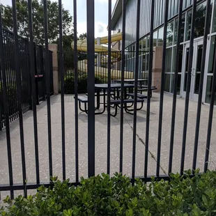Fenced in picnic area outside of the indoor pool.