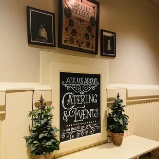 a kitchen with a chalkboard and potted plants